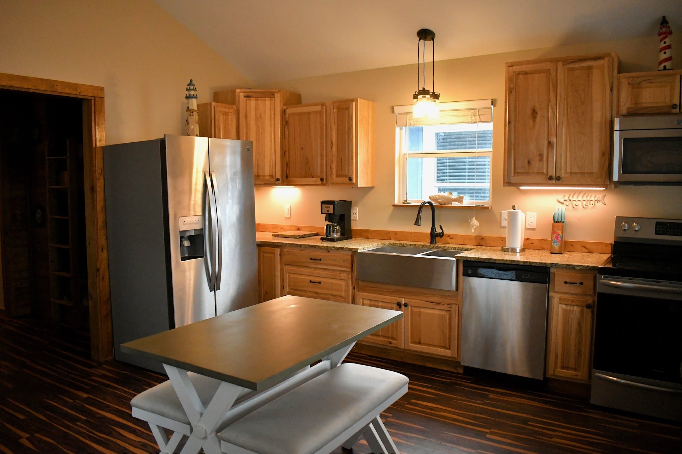 a kitchen with wooden cabinets and a dining room table