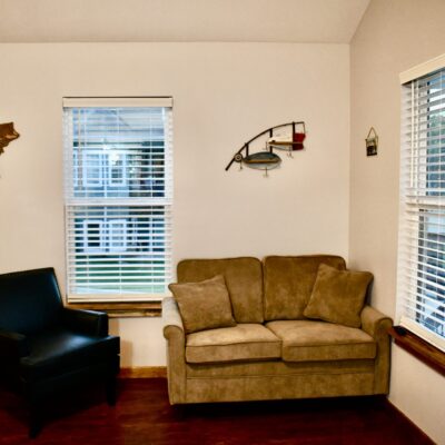 A Living Room Filled With Furniture And A Large Window